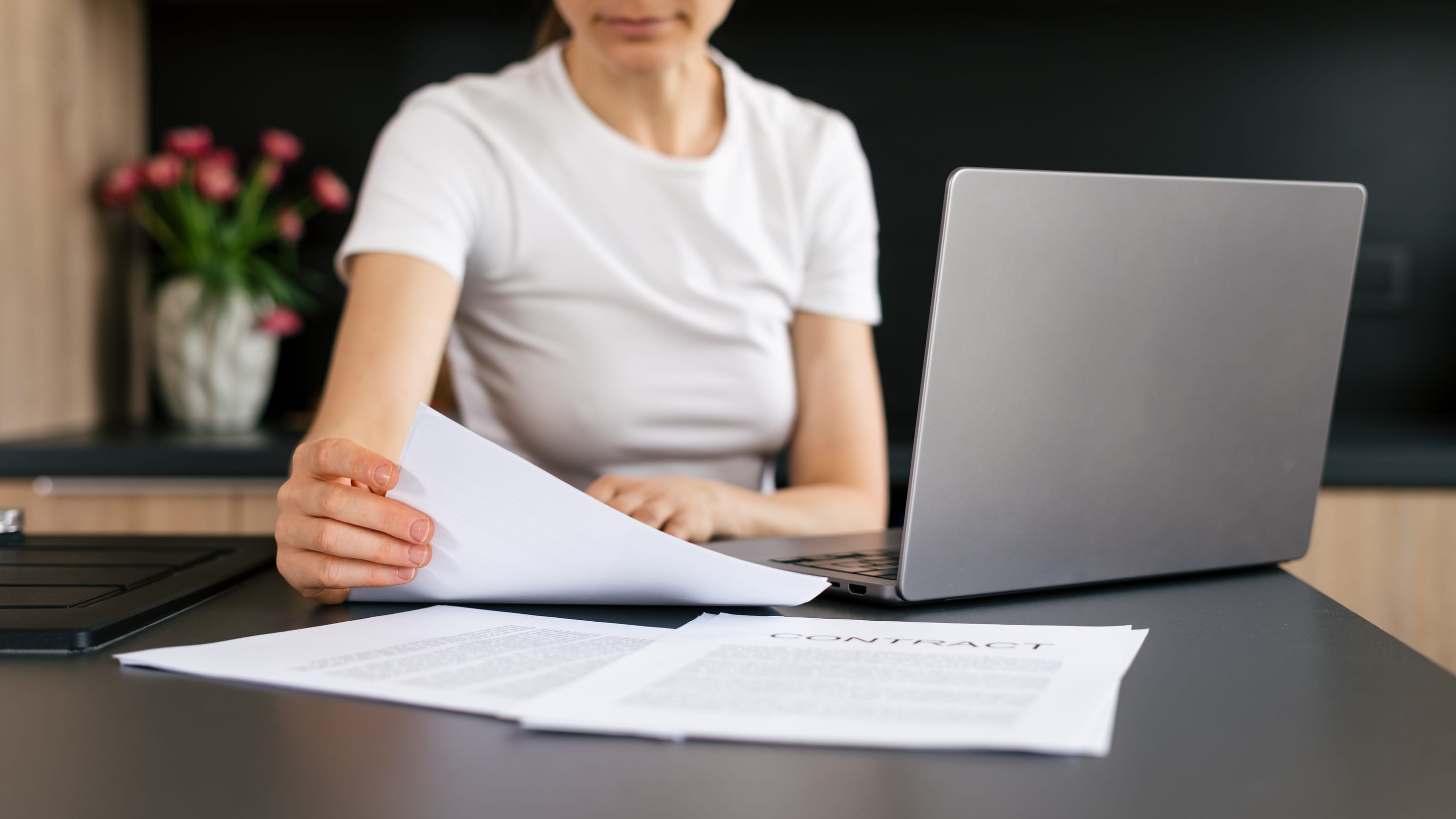 HR professional reviewing Employment Pass application documents at a Singapore clinic 
