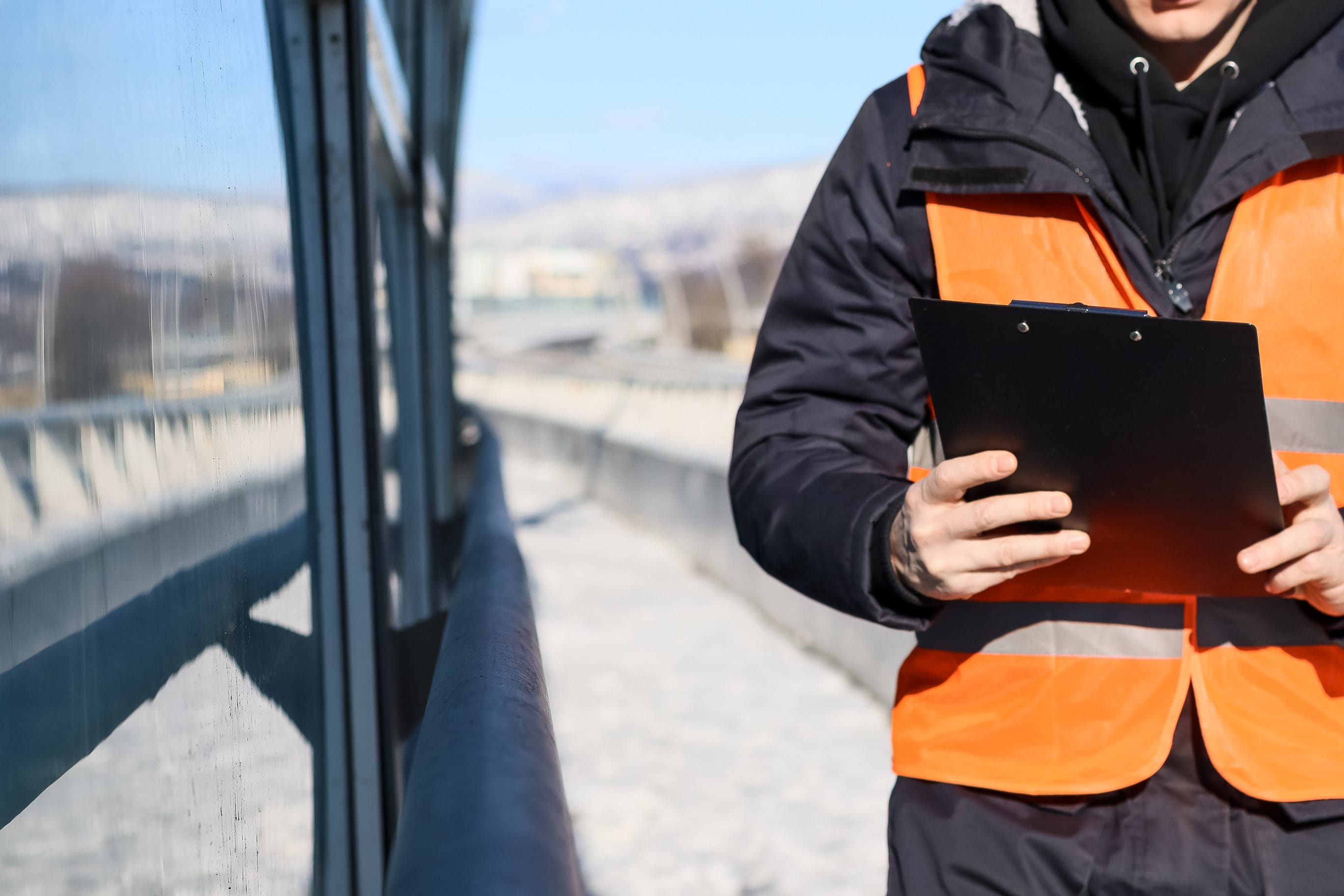 Skilled technician in Singapore workplace holding work pass documentation