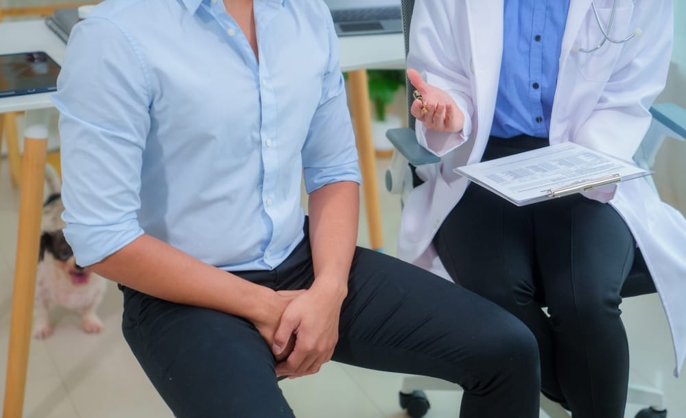 Doctor consulting patient about syphilis symptoms at a Singapore clinic